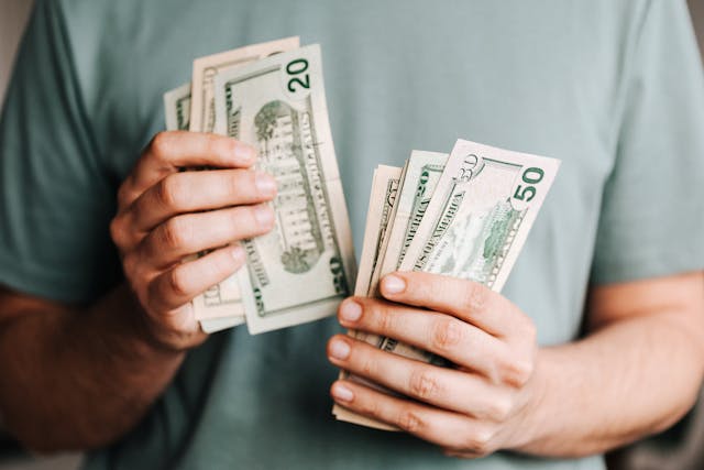 Person counting money in their hands